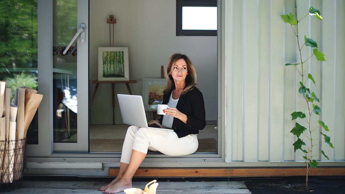 woman enjoying working in her garden room